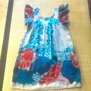 Sheer poppy dress with flutter sleeves. Big splashy stylized flowers.